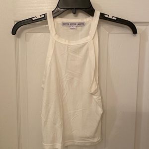 Fitted white tank with high neck.